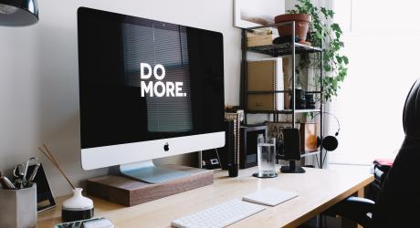 An iMac showing the phrase "do more"