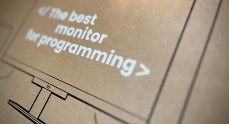 Cardboard box with the text, the best monitor for programming printed on the side.