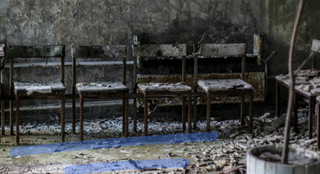 Row of rotten wooden chairs