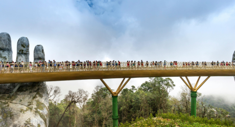 A bridge held up by huge stone hands