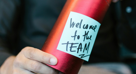 A man with a gift welcoming him to the team