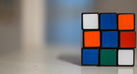 An unsolved Rubiks cube on a table